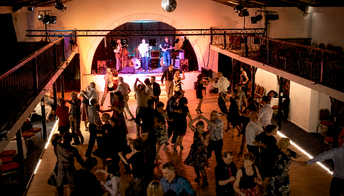 Couples dancing lead and follow at an Aspirations Dance class